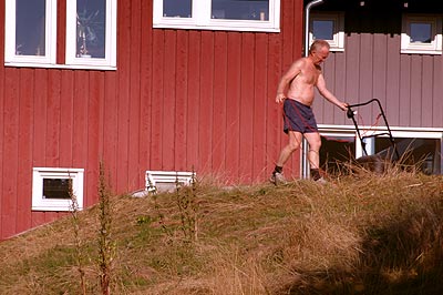 It's a man. Mowing the roof.